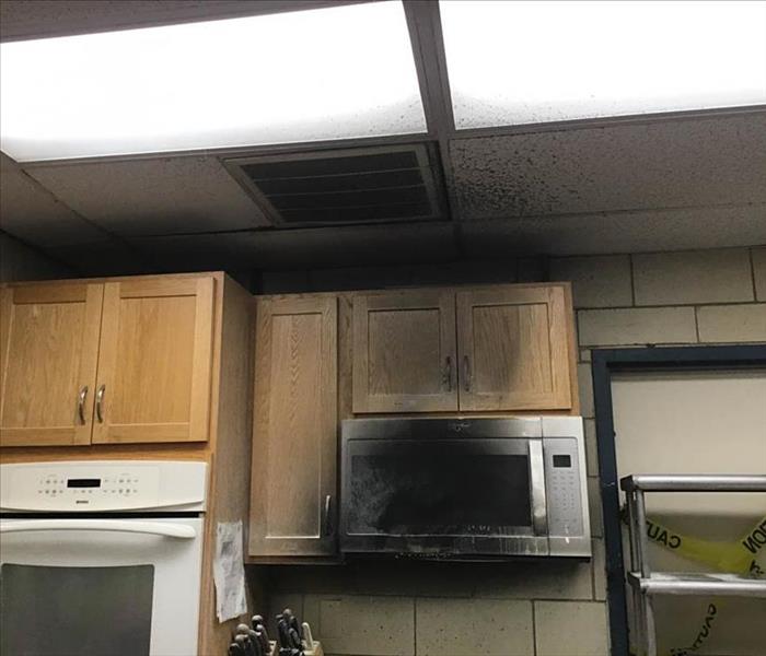 Kitchen fire damage on microwave and cabinets