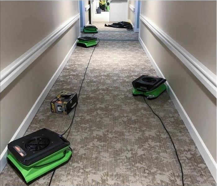 Air movers placed in the hallway of a commercial building