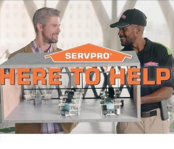 Here to Help - image of SERVPRO employee talking to customer